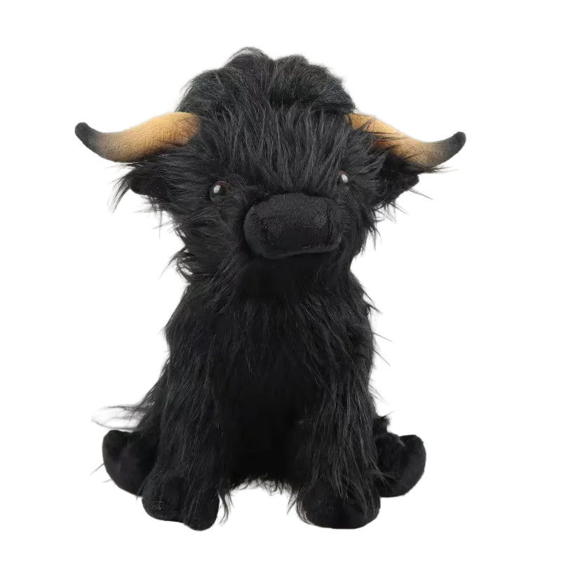 Plush toy of a black highland cow with brown horns on a white background