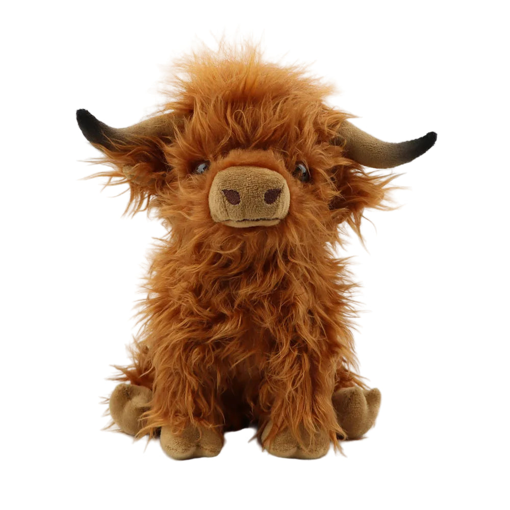 Plush toy highland cow on a white background